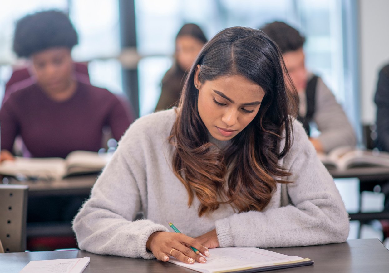 Female Indian University Student Writing stock photo